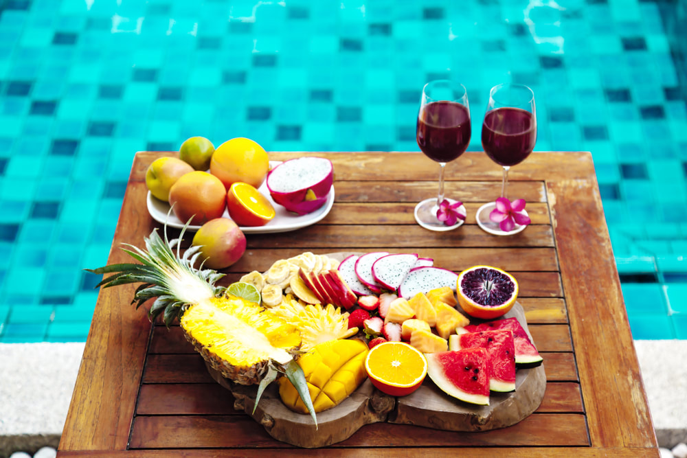 Tropical fruit and wine by the pool